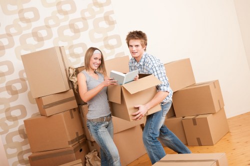 Professional movers carrying furniture during a small removals service in Ratcliff
